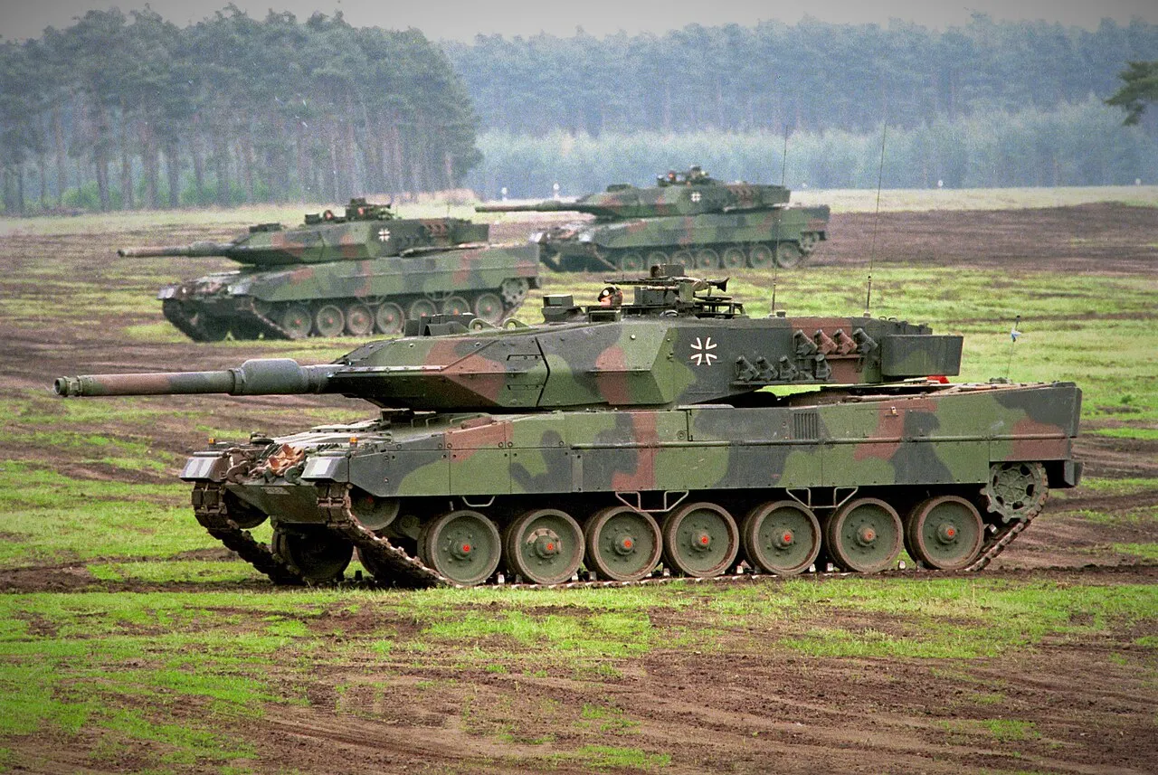 A Leopard 2A5 main battle tank in woodland camouflage during a Bundeswehr demonstration.